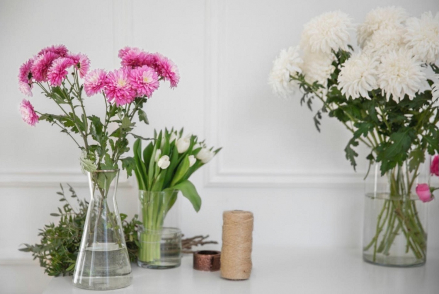 Floristry student workspace showing arrangement materials and reference guides